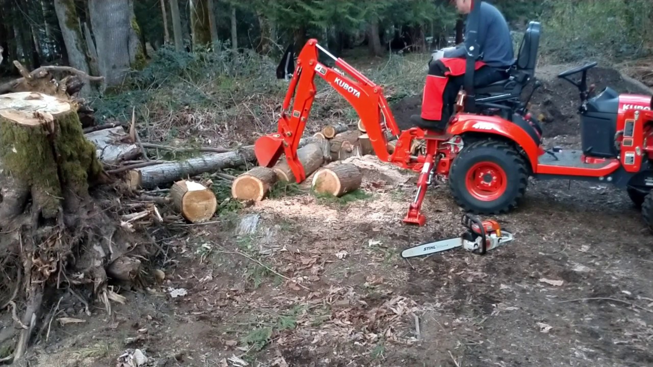 Kubota Sub Compact Tractor backhoe Mechanical Thumb cutting firewood using the STIHL MS 260 Chainsaw