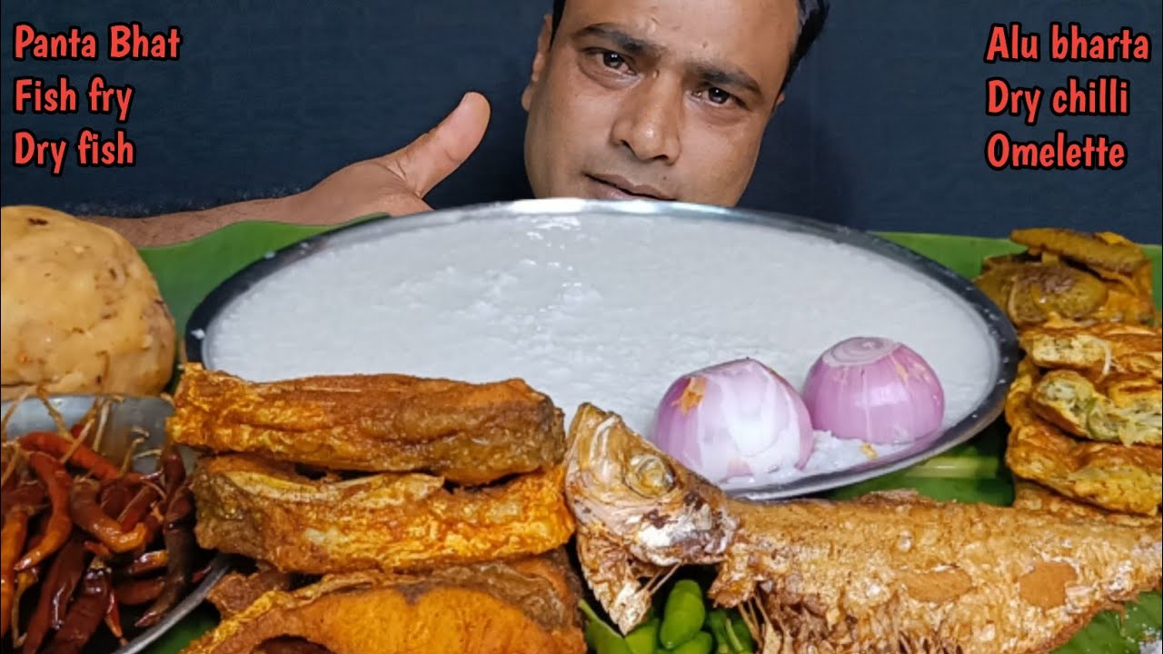 EATING PANTA BHAT/WATER RICE, FISH FRY, DRY FISH, ALU BHARTA, DRY CHILLI, EGG OMELETTE AND ONION
