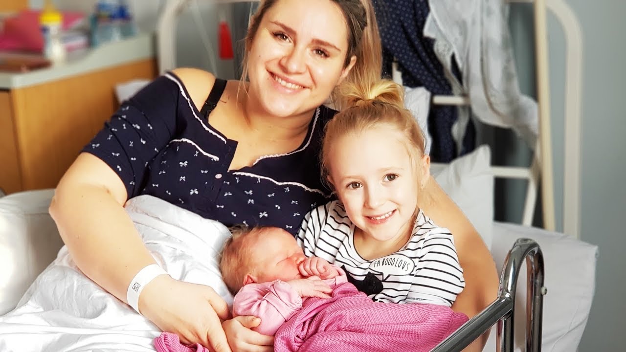 Little girl meets her newborn baby sister for the first time