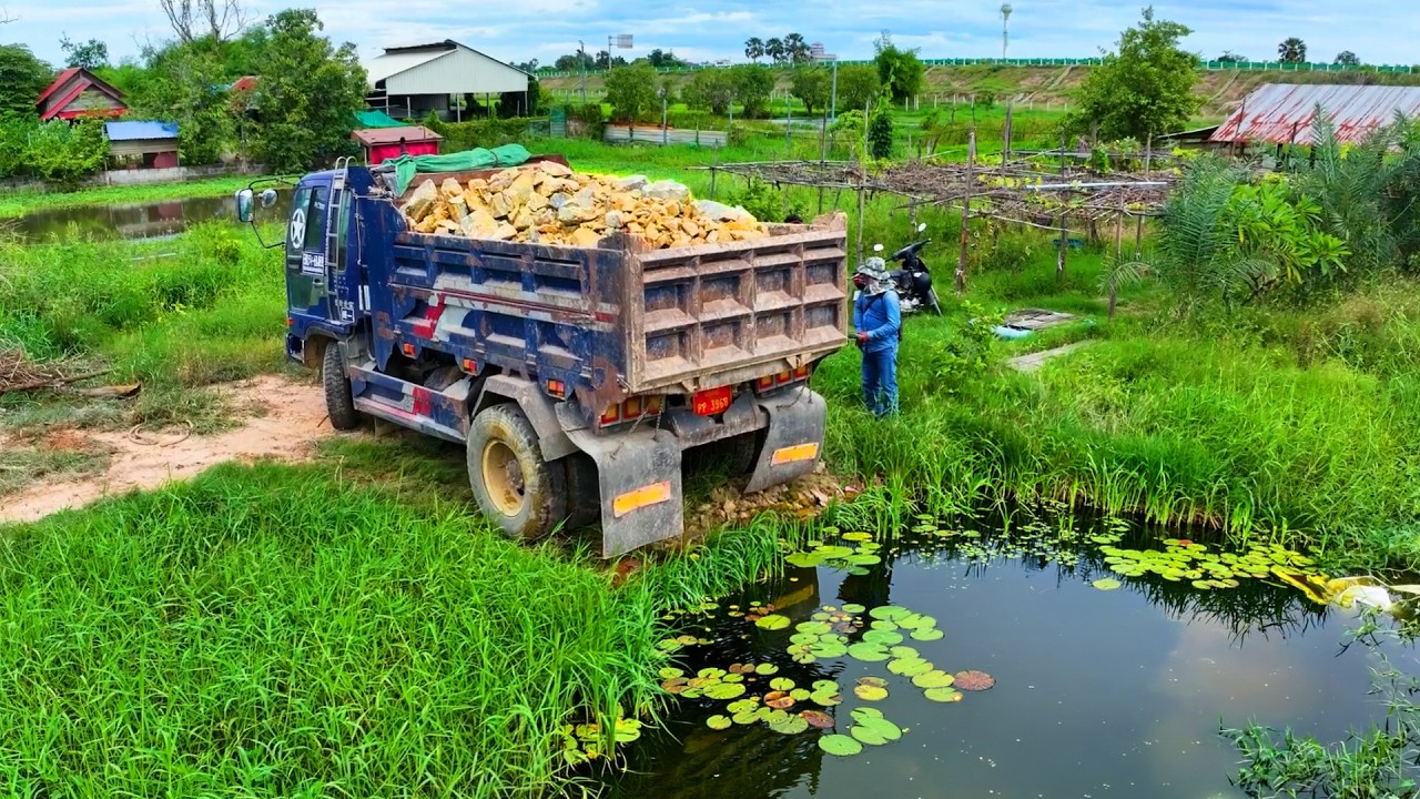 incredible delete pond landfill build factory project , truck transport stone soil , bulldozer push