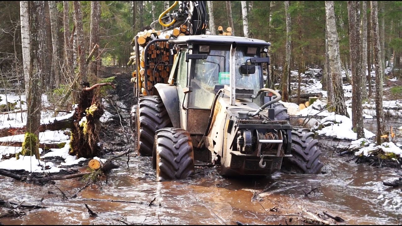 Valtra forestry tractor, John Deere 1110D and Timberjack 810B logging in wet conditions