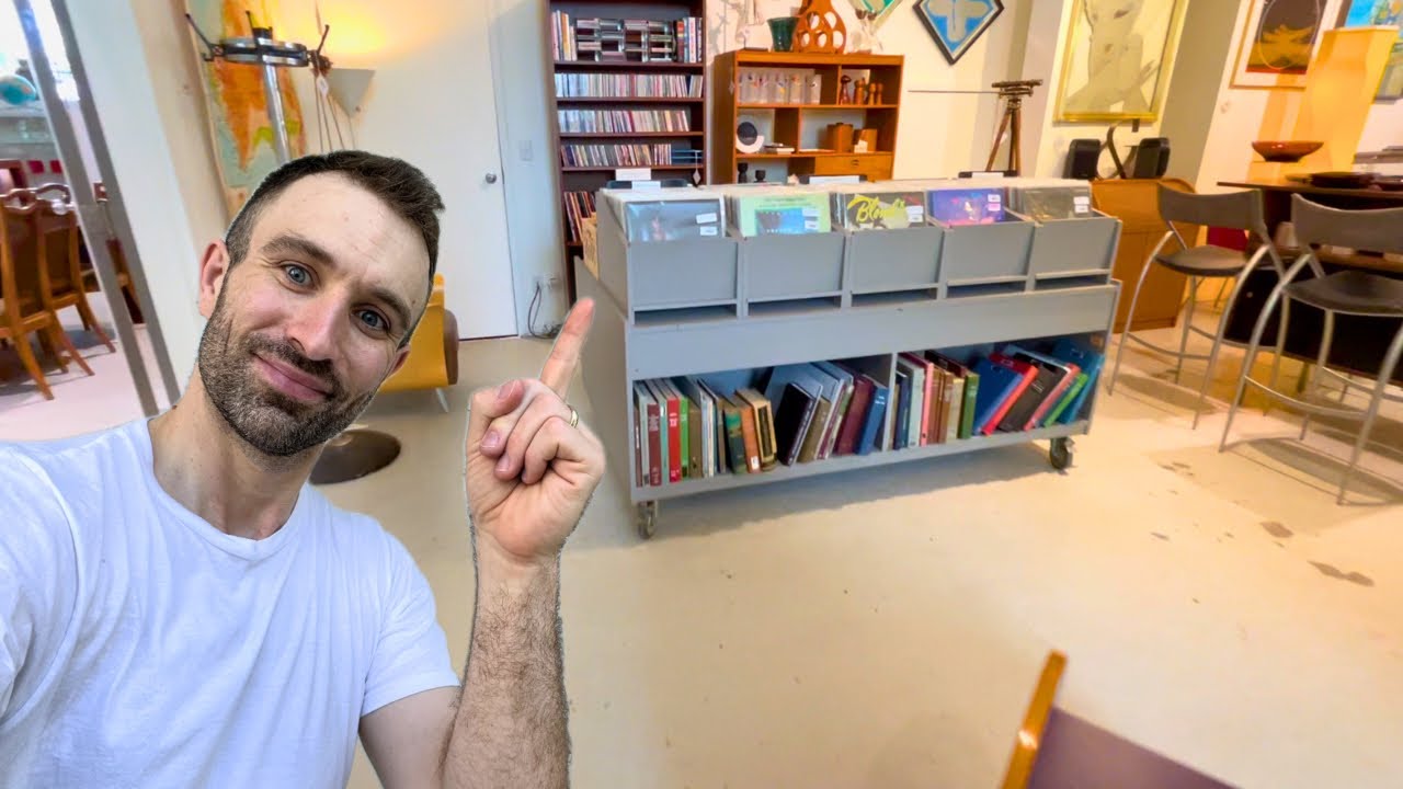 Flipping Through Vinyl Records in a Vintage Furniture Store