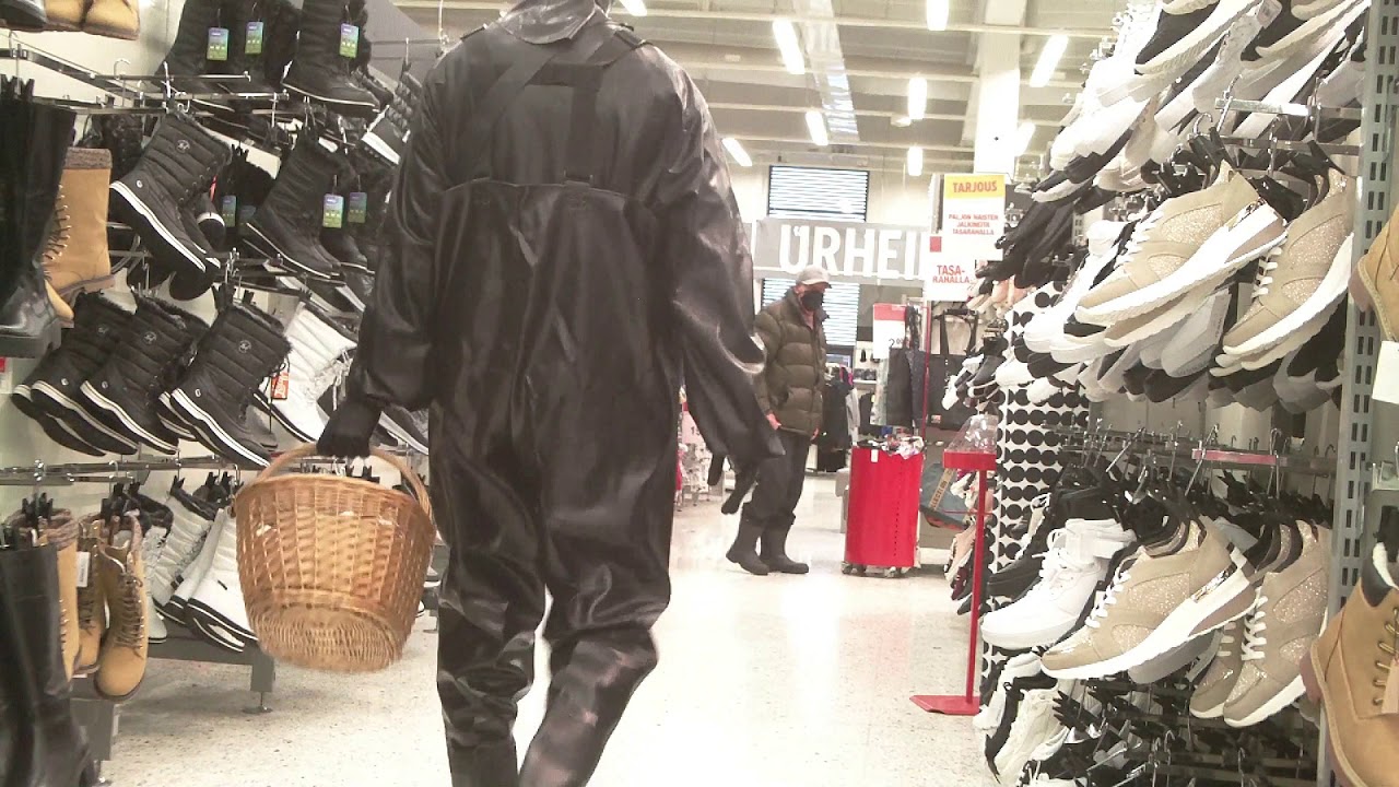 shopping in black waders and rubber suit