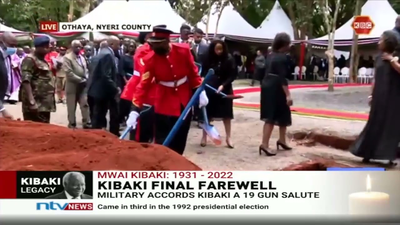 Burial: Mwai Kibaki's grandson, Sean Andrew, throws his ring in the grave