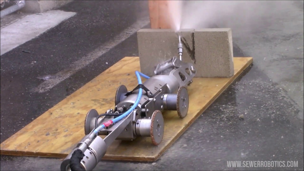 Water jet robot cuts through cement to demonstrate sewer blockage removal
