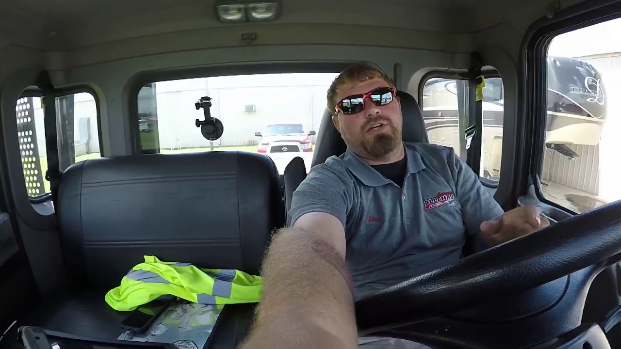 Walking a flatbed wrecker under a vehicle in reverse