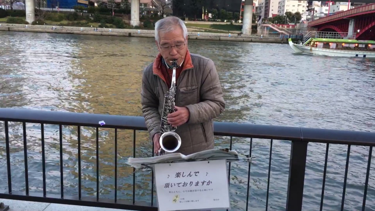 Saxophone street singer at Sumidariver Asakusa, Tokyo