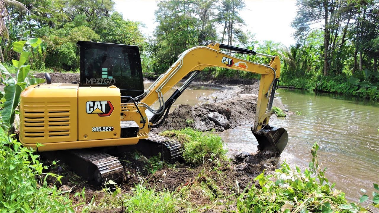 Mini Excavator CAT 305.5E2 Working On The Fish Pond