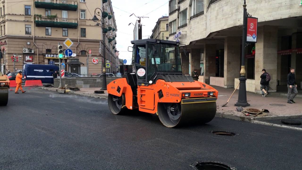 Russian road construction workers fix the road - Sep 2, 2016 - Saint-Petersburg, Russia