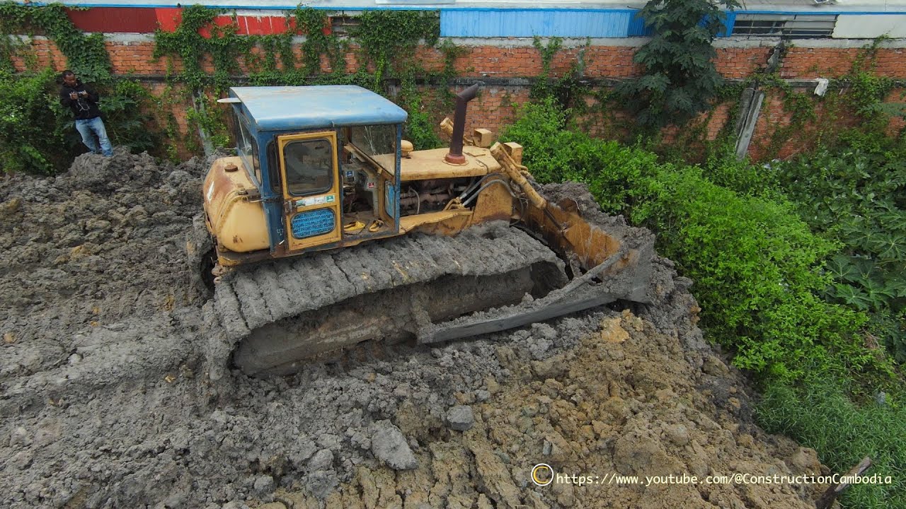 The Power Big Old Komatsu Bulldozer Pushed The Dirt And Dump Trucks Dumping Dirt
