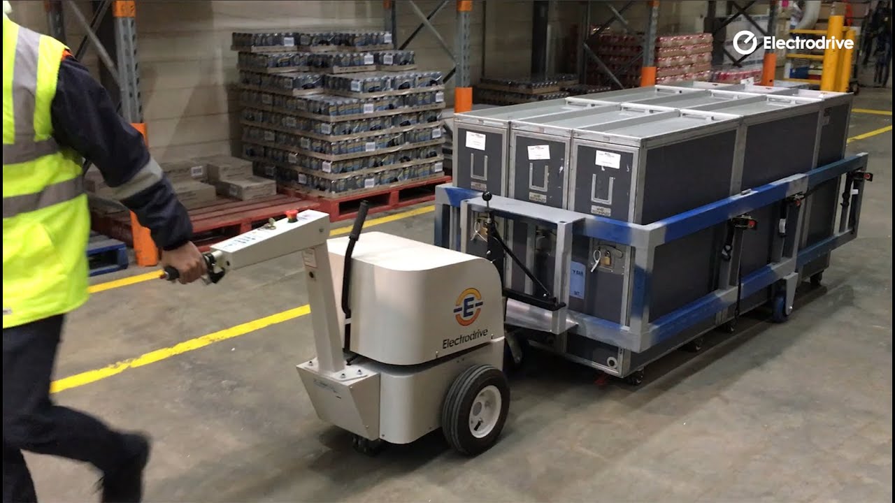 Electric tug pulling an adjustable cart mover trolley | Powered materials handling | Electrodrive