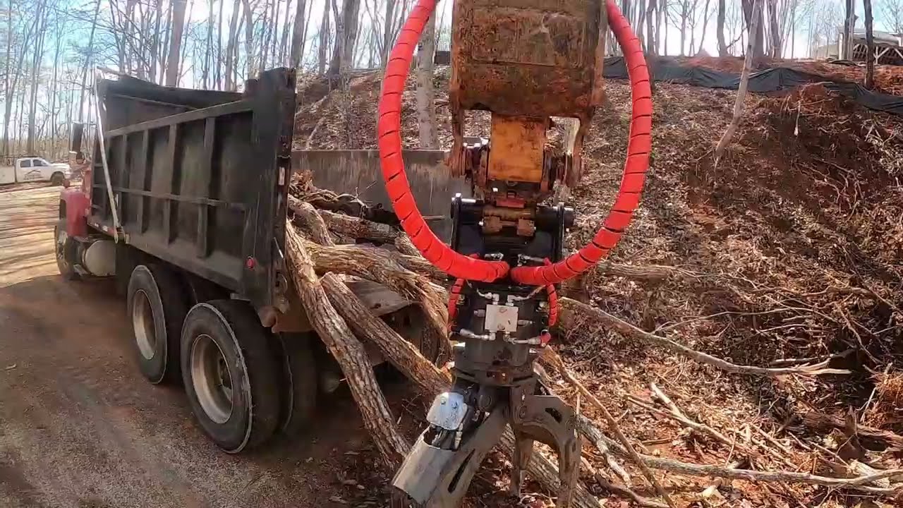 Cat 306 and Ryan's Equipment Grapple.  Brush Loading fools