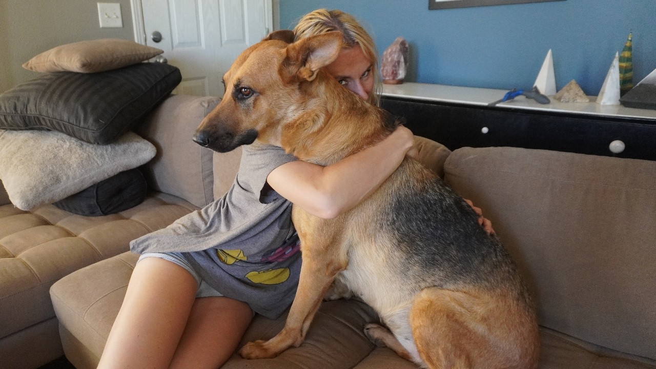 COUPLE HUGGING OUR DOGS FOR TOO LONG