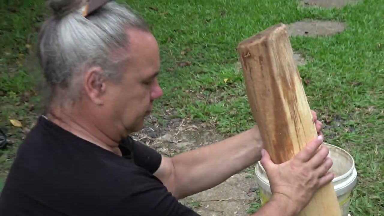 Warren Warbrick demonstrates Maori woodworking with a stone adze (toki)