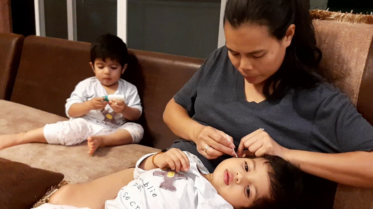 Mommy cleaning ear of Mevin