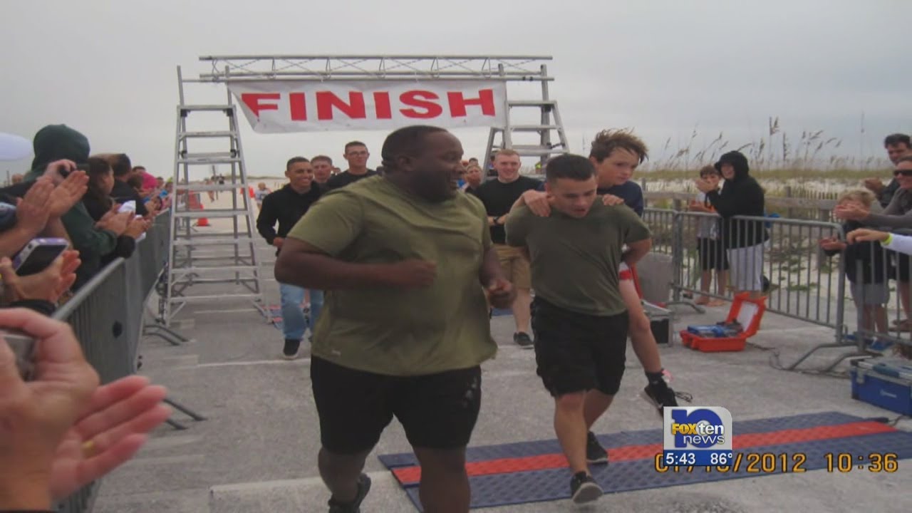Marine honored for carrying triathlete across finish line