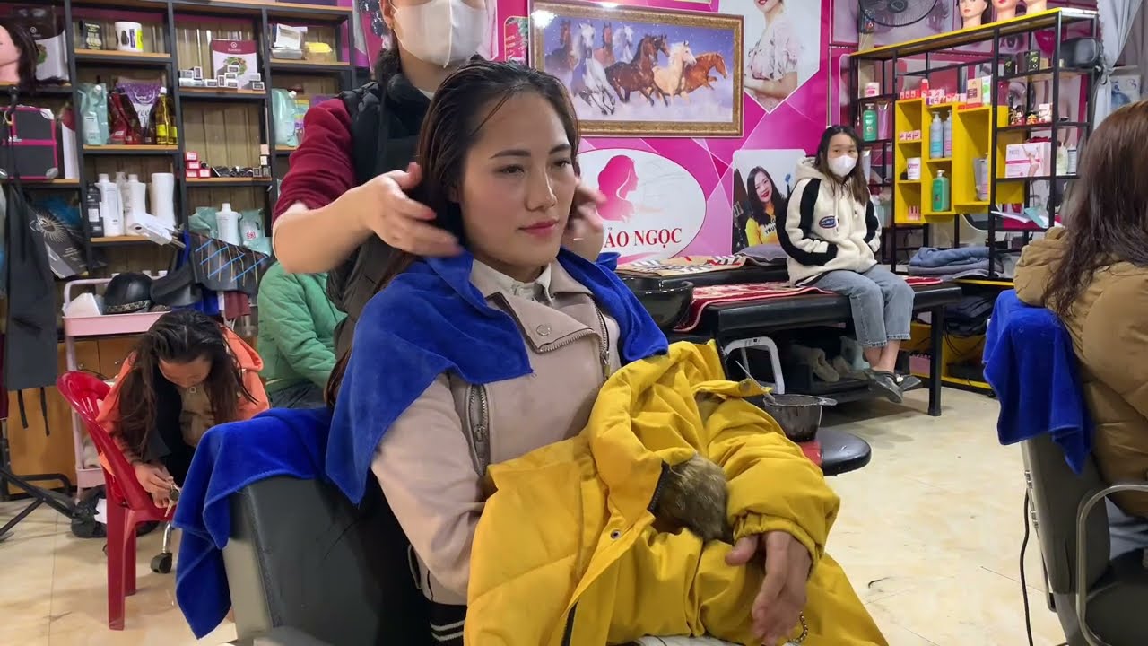 Washing the car and drying it on a busy day, she still took the opportunity to get her hair done.