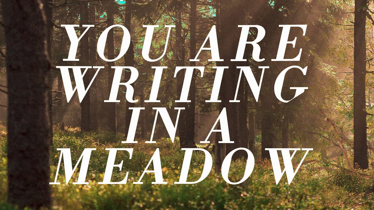 You are writing in a meadow to distant guitar. Nearby, a stream runs.
