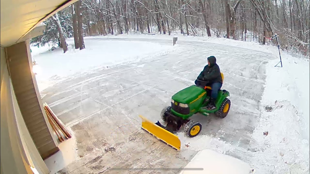 John Deere X series 4x4 Tractor Clearing Driveway Snow