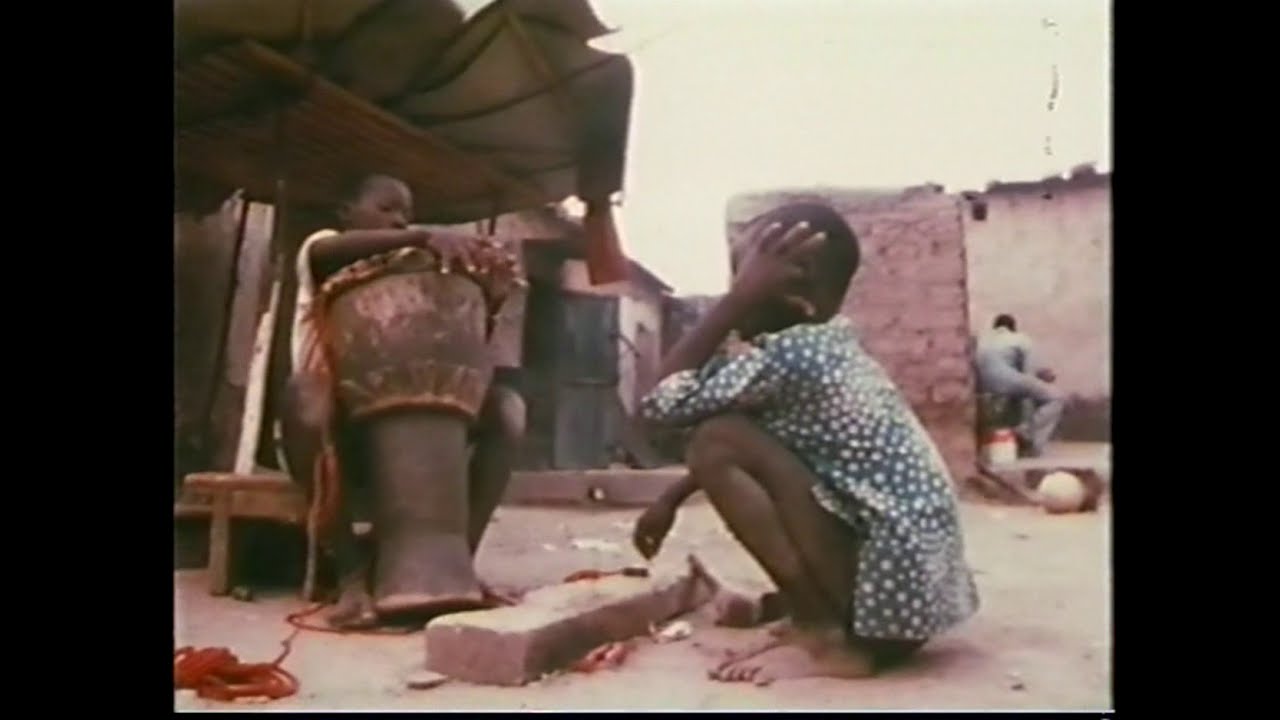 KALIFA KONE heads a djembe, KIEMOGO KONE helps - JELI (Griot) Family in BURKINA FASO, West AFRICA