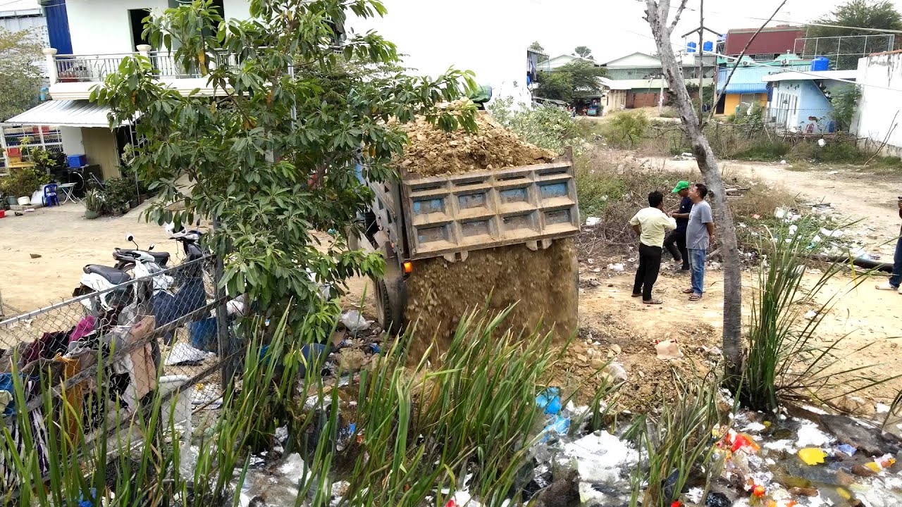 Work plan for machinery to push rocks, soil, grass, water, and garbage into a location