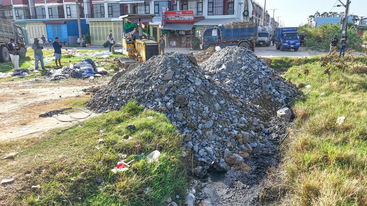 Process delete ditch to build road use Stone smoothly work by skill KOMATSU D31P dozer ,5T truck