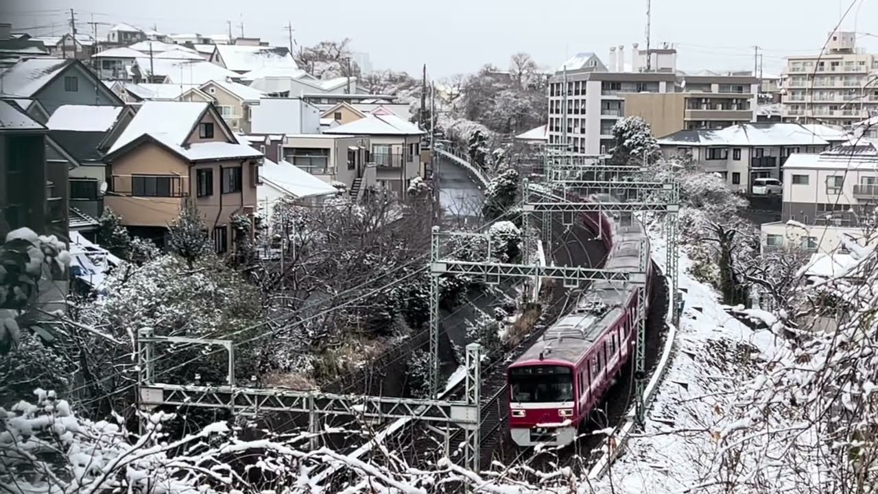 雪景色の富岡(横浜)を行く京急線