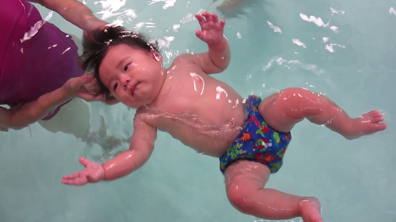 Asian baby swimming happy