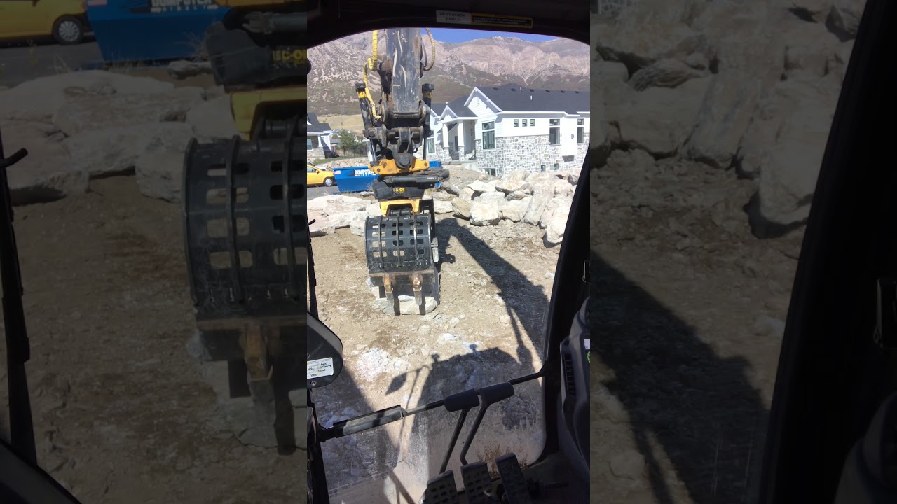 How To Set a Rock Wall using a Engcon Grapple on a Deere 250G Excavator