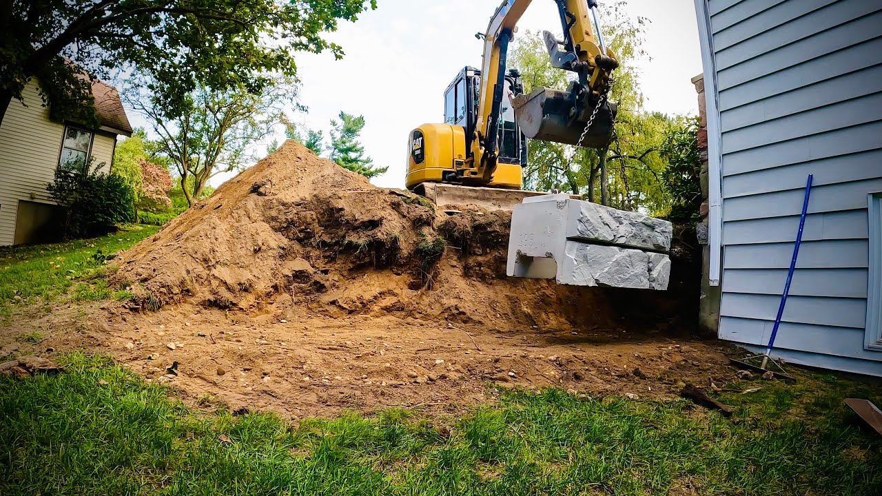 Landscape Company Using Caterpillar 305E2 To Build Verti Block Wall