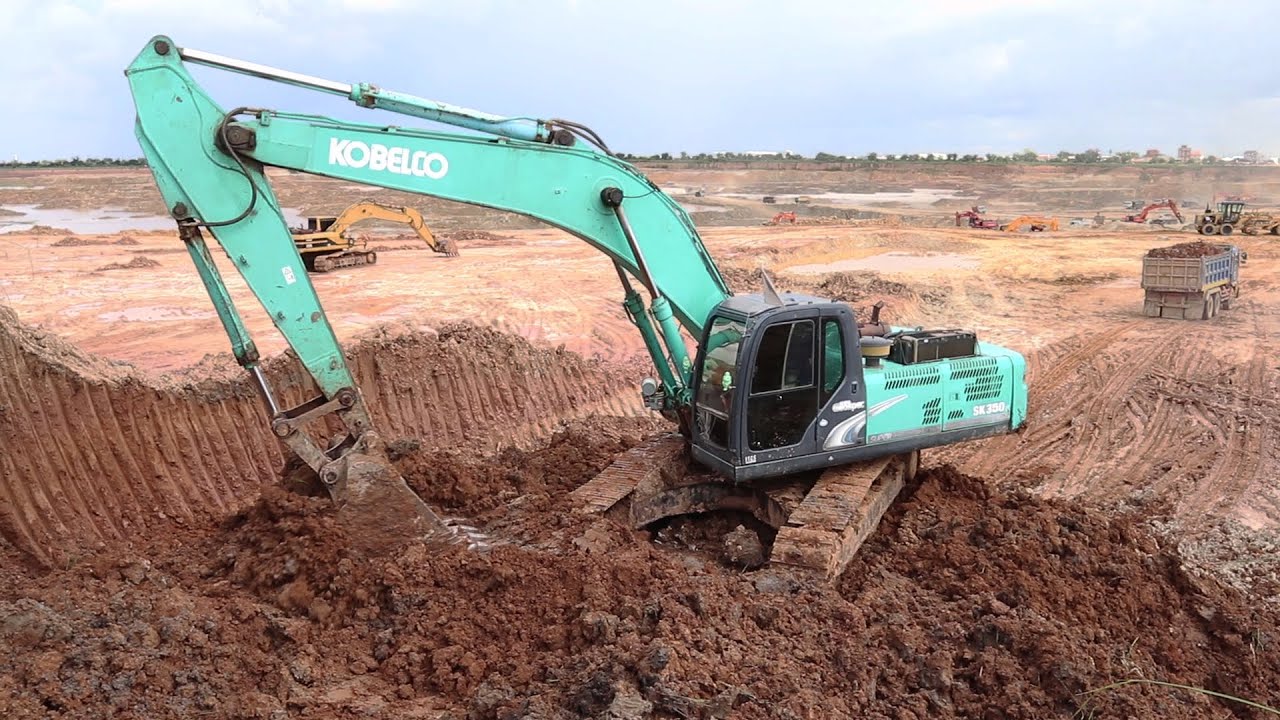 Excavator Kobelco SK350 Digging Soils & Loading Dump Truck / safety loading soil on Truck