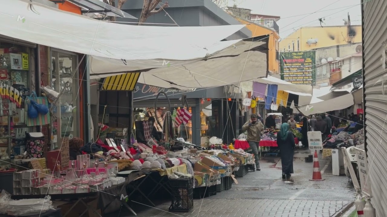 Bustling outdoor market street with colorful stalls and vibrant atmosphere
