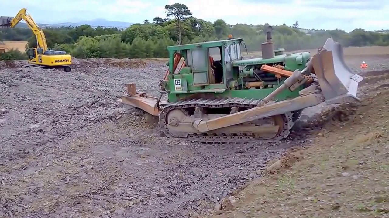 CAT D9G dozer machine ripping rock in a quarry for road construction