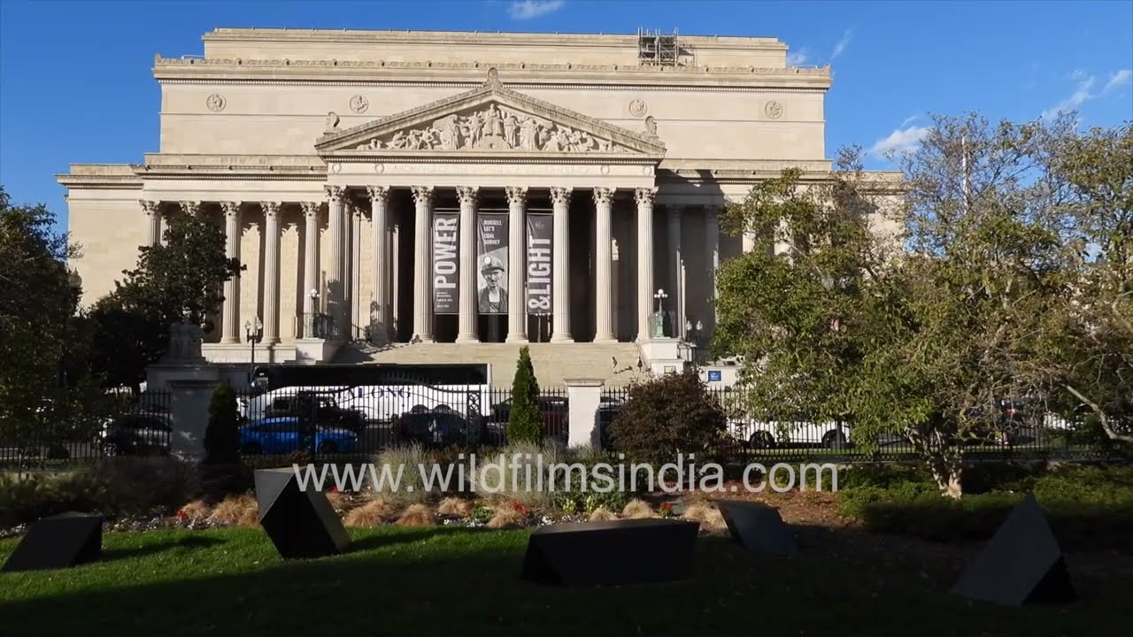 The National Archives Building in Washington, D.C., stands proudly under a bright blue sky