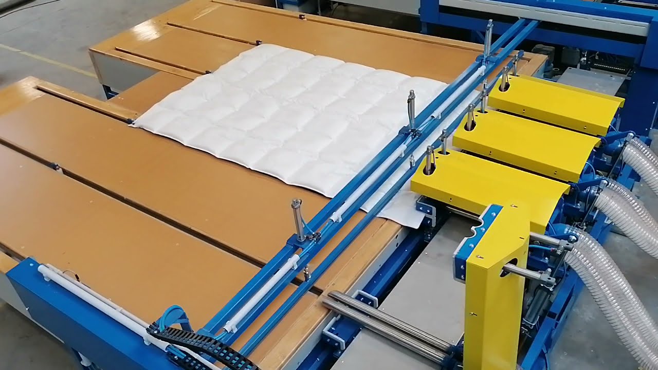 8 pipe duvet filling  machine in operation (from an elevated position)
