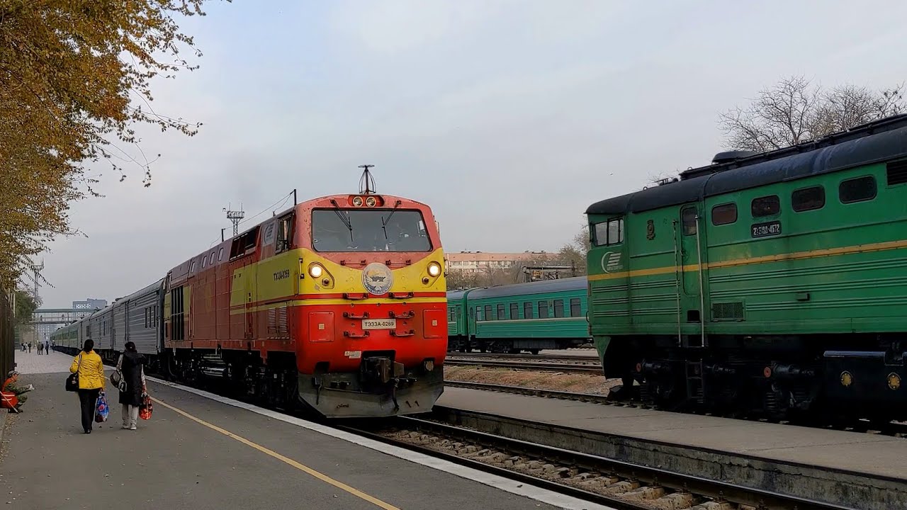 Diesel locomotive TE33A-0269 with a passenger train departs from the Bishkek-2 station.