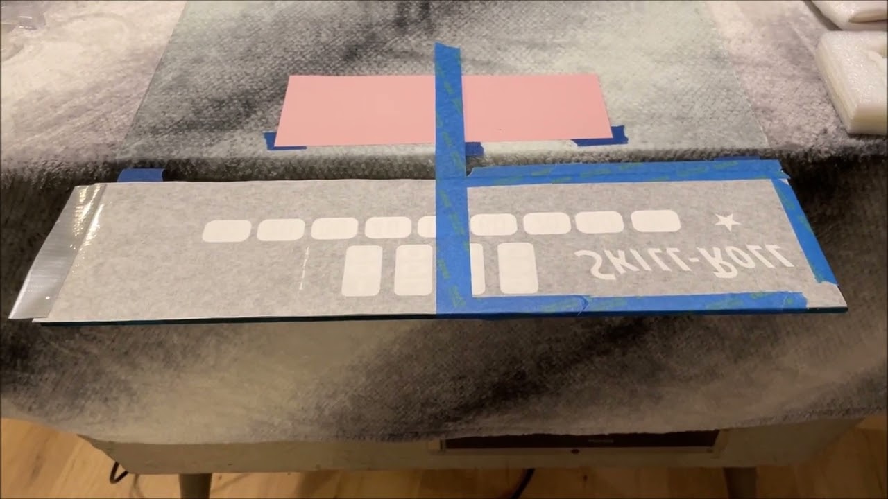 Applying Bally Skill Roll decal onto glass