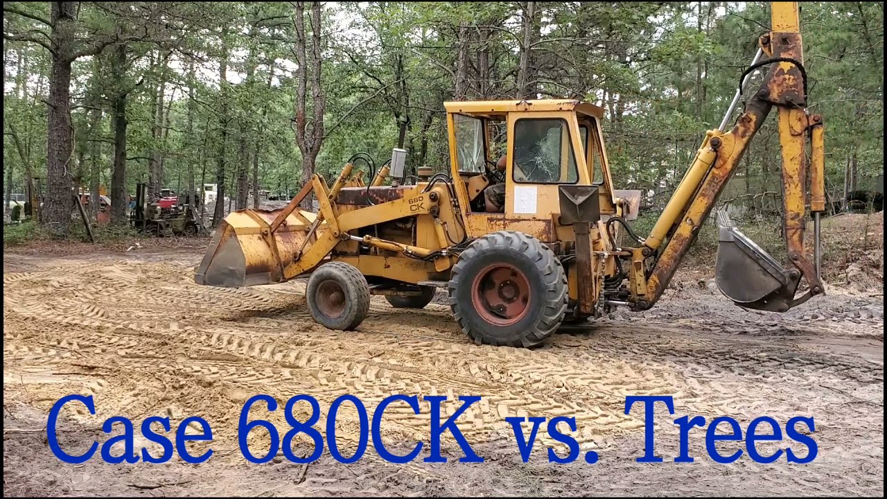 Digging out pine trees with a backhoe, Case 680CK