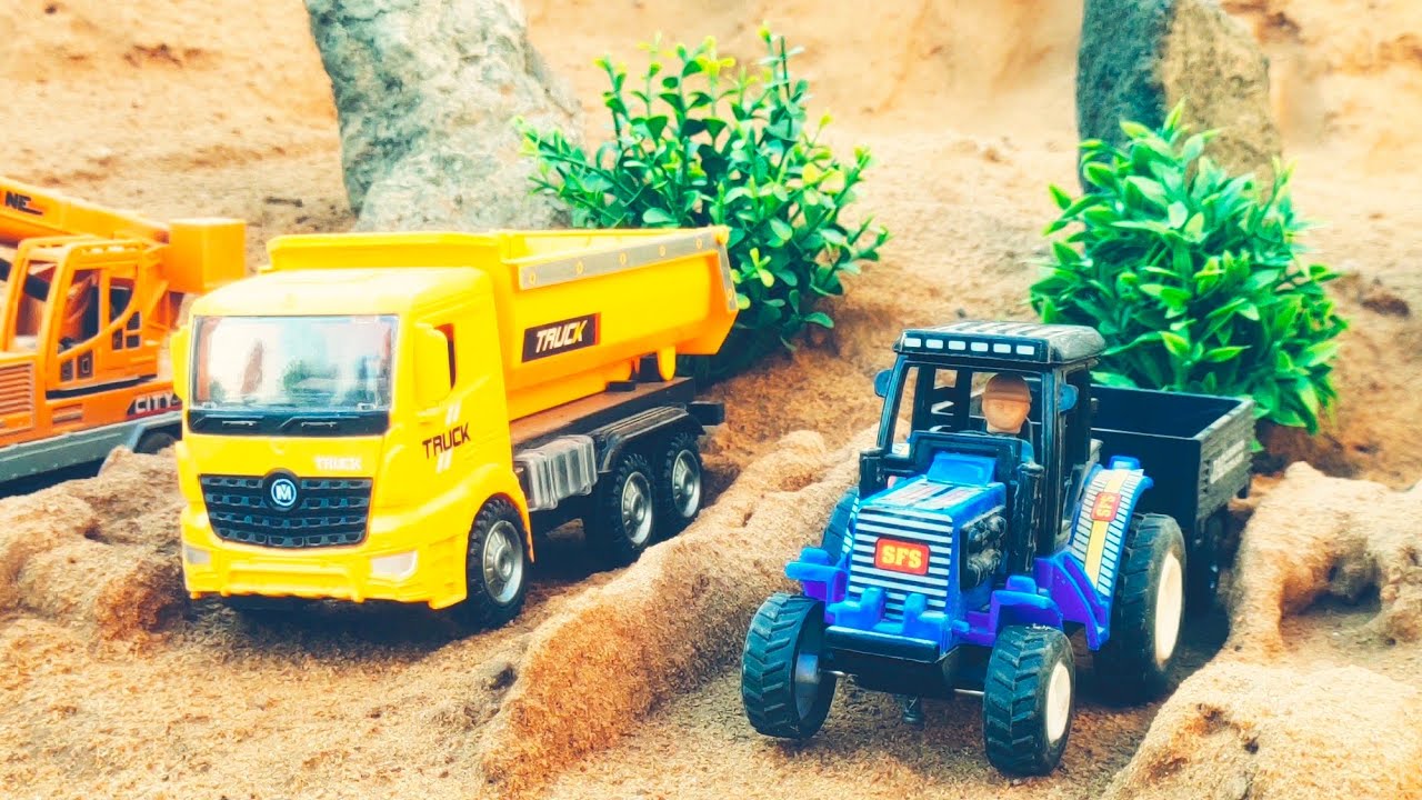Mini construction vehicles running in desert area bring sand