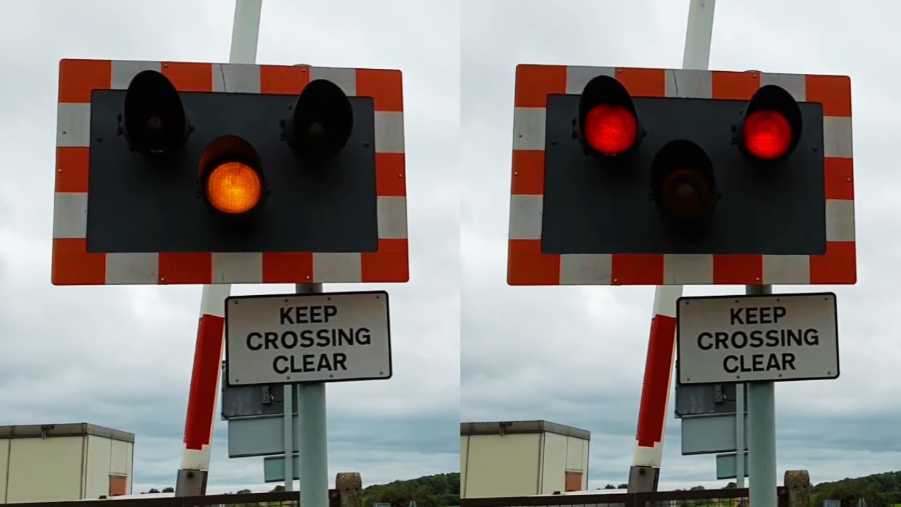 Two Trains Passing Bield Drove Level Crossing with Halogen Lights