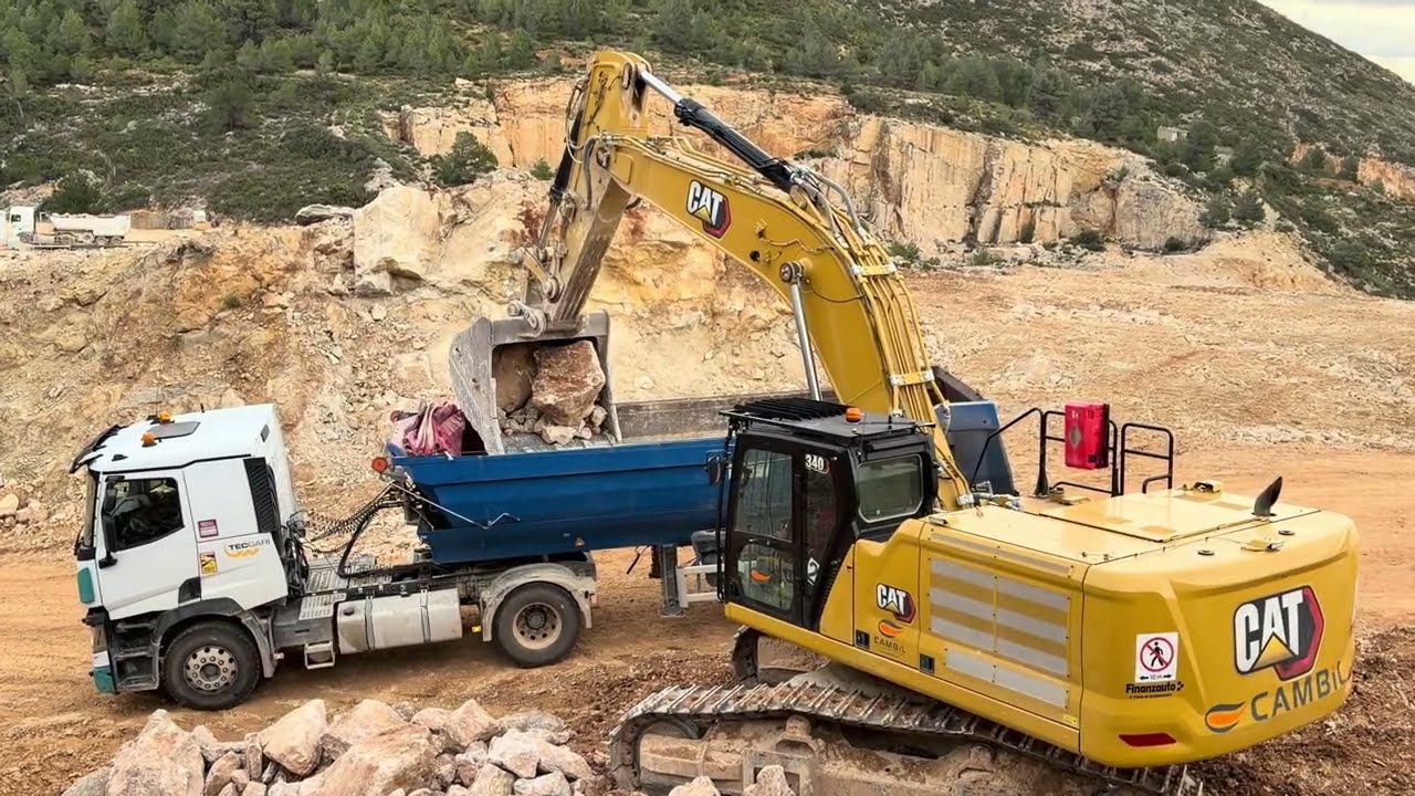 CAT 340 NEXT GEN Excavator Loading Rock into Semi Truck
