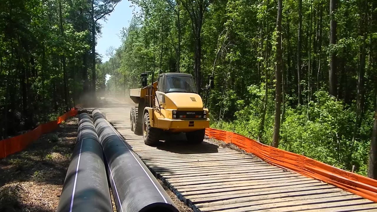 Crane mat road, laminated mat road with Cat 725 for pipeline mat work.