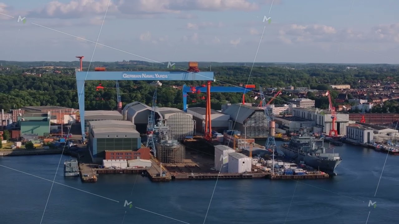 Aerial view of the German naval yards shipyard in Kiel, Germany. Camera shows the large cranes and