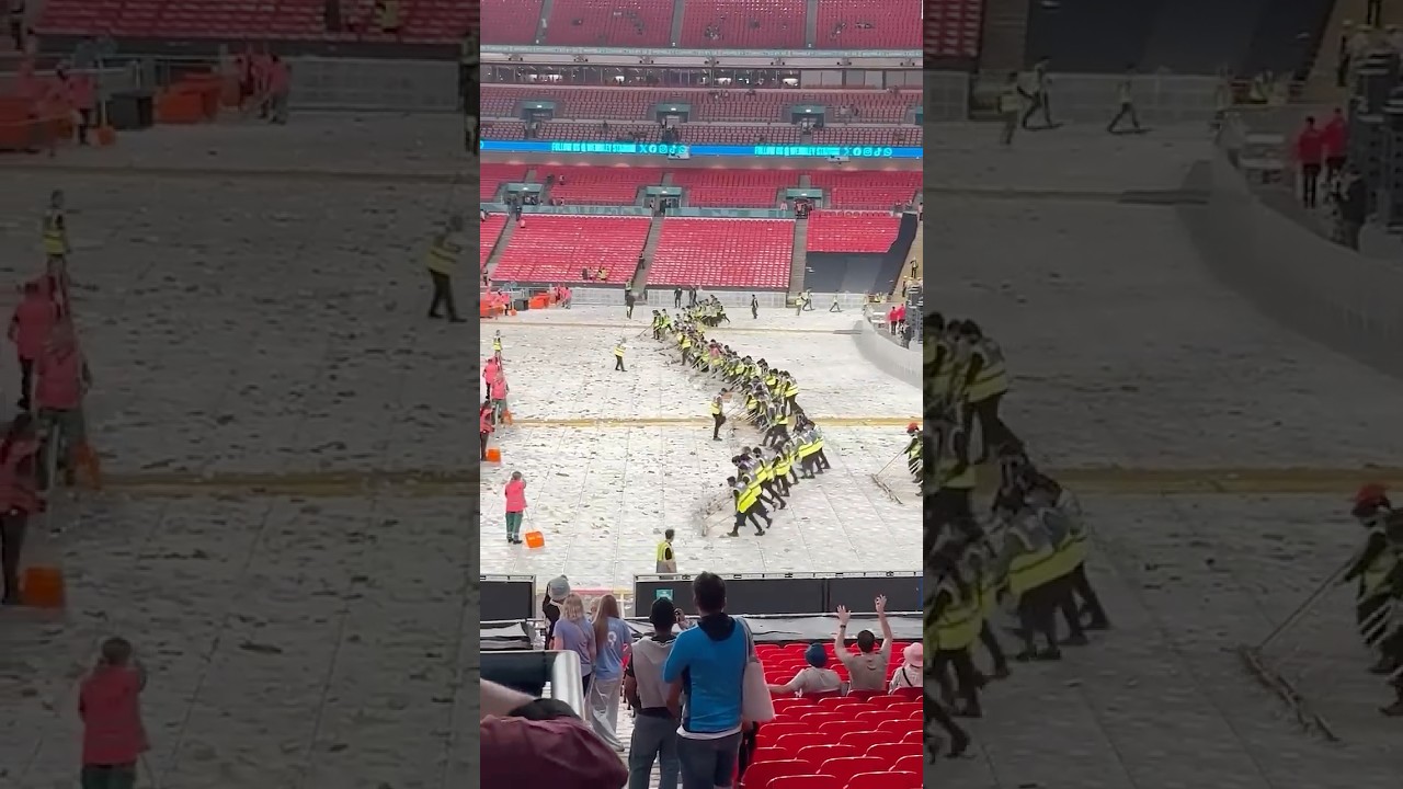 Cleaners create a 'wonderwall' to clear beer cups at oasis concert