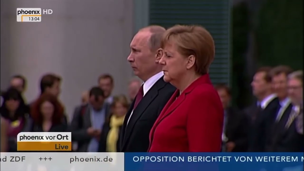 Putin and Merkel Putin listen to the Russian national anthem on 1 June 2012 in Berlin