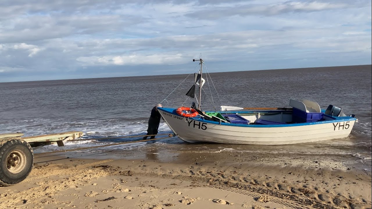 Sea fishing trip launching off the beach. Boat netting trip herring & sprats. Angling fish bait  UK