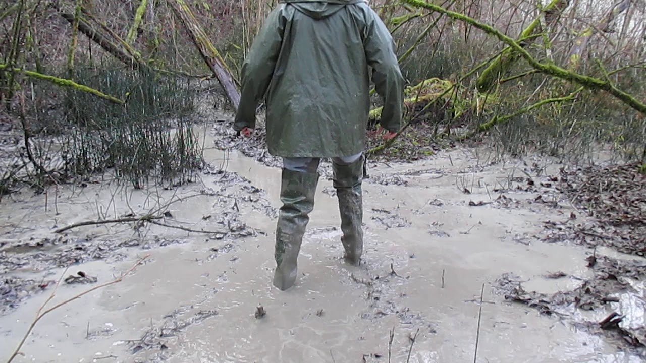 Green waders in a mud pit
