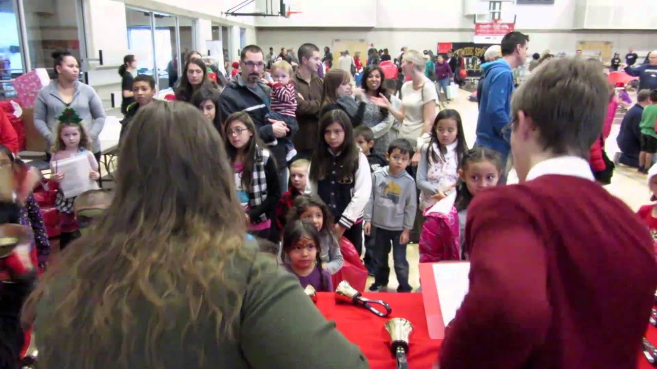 Matthew Compton and band conduct hand bell performance at Santa's Elves 2014