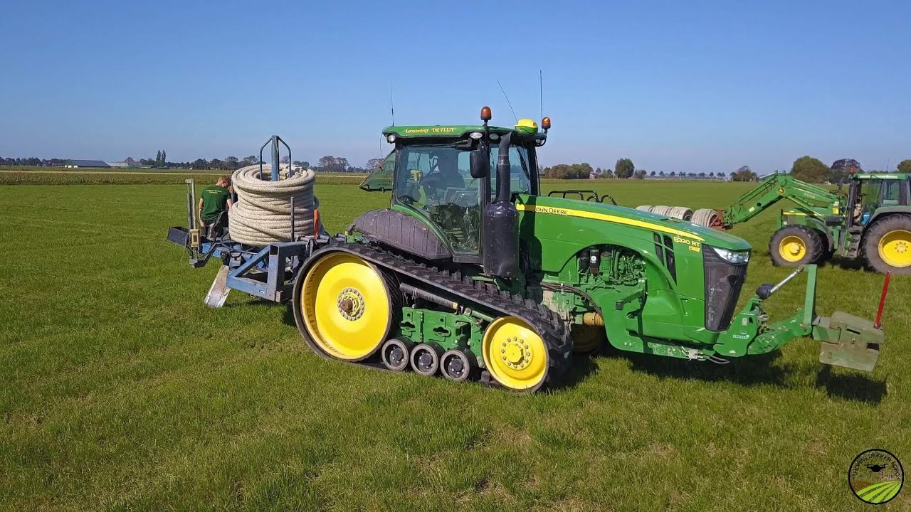 Contractor de Vlijt laying trenchless field drainage with a John Deere 8320RT