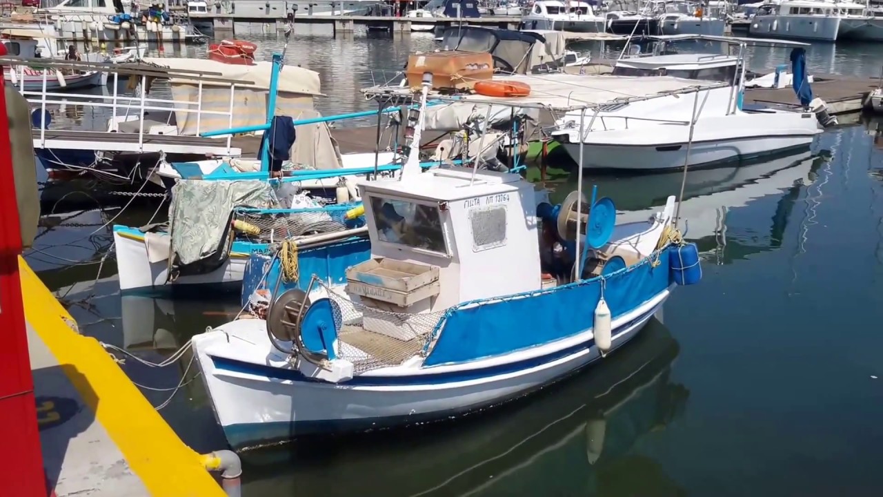 Small beautiful, compact, fishing boats in Piraeus Zea harbor, near Athens, Greece. May 2017.